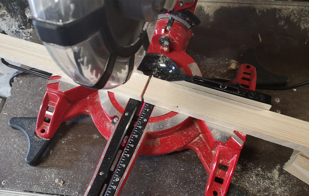 The wooden board is fully cut through with the Einhell miter saw.