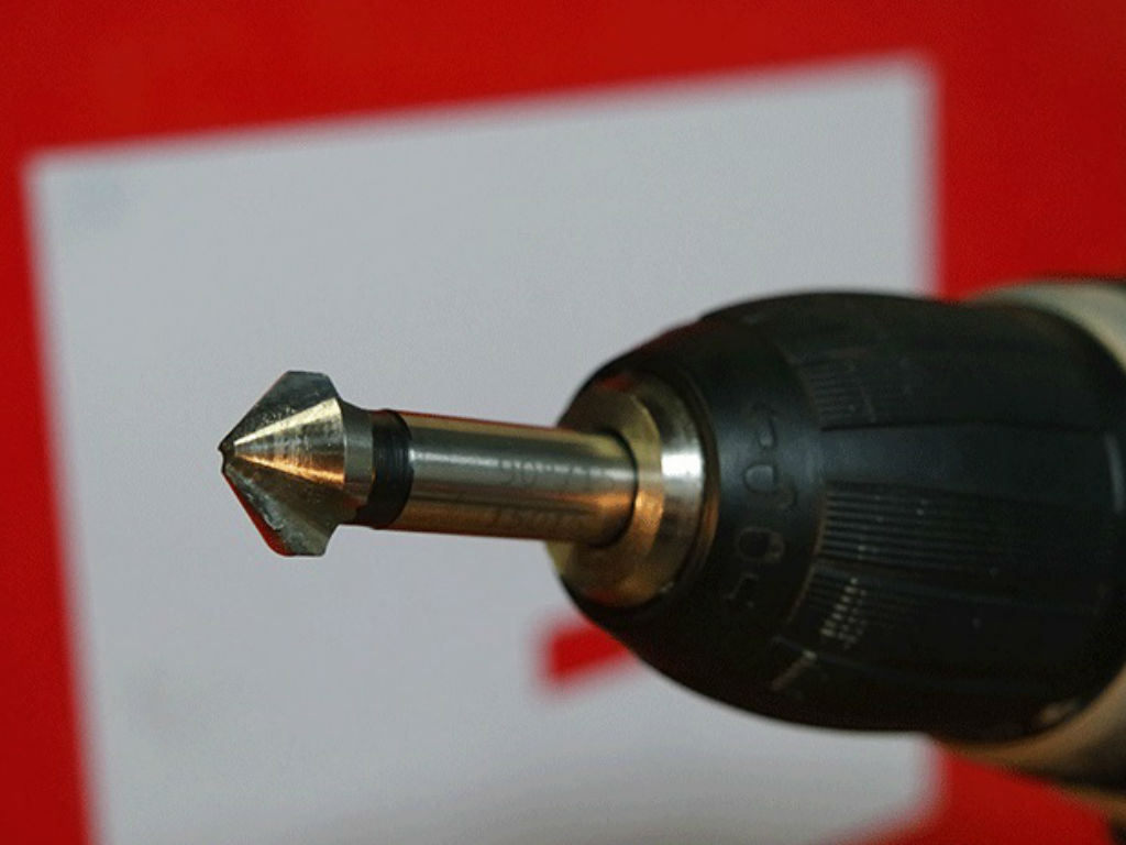 A countersink attached to a cordless screwdriver.