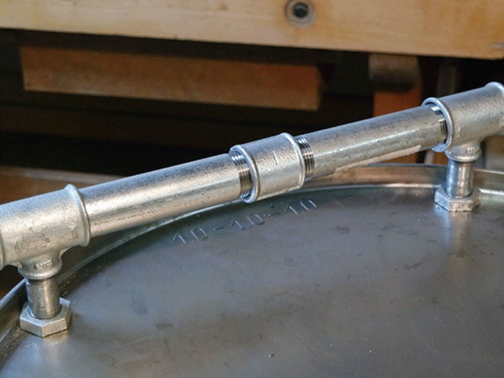 A pipe attached to the side of the smoker.