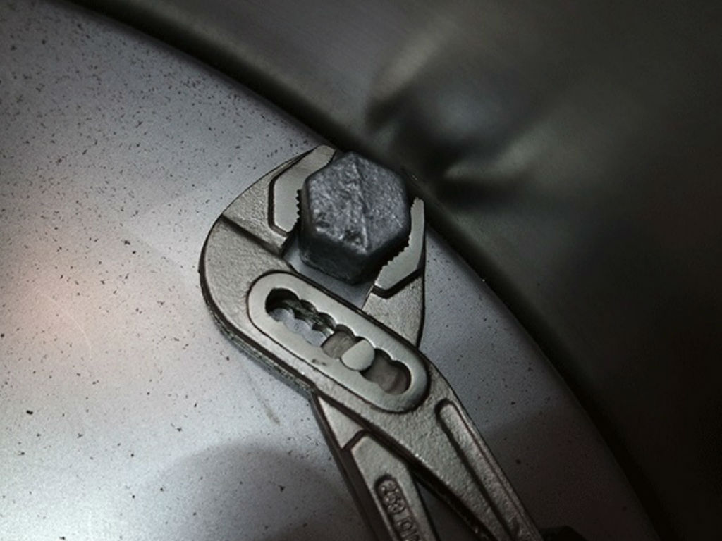 Screw head is held in place with pliers
