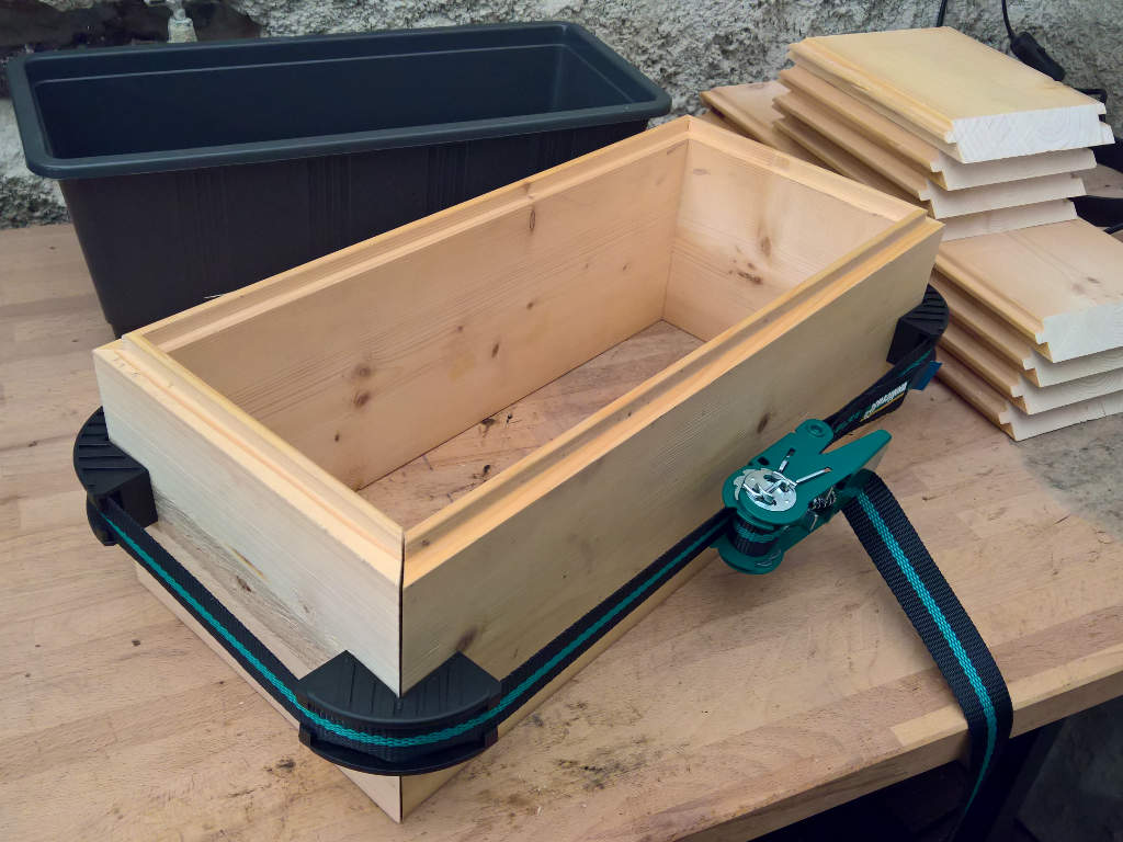 A wooden box is held together with a tension belt