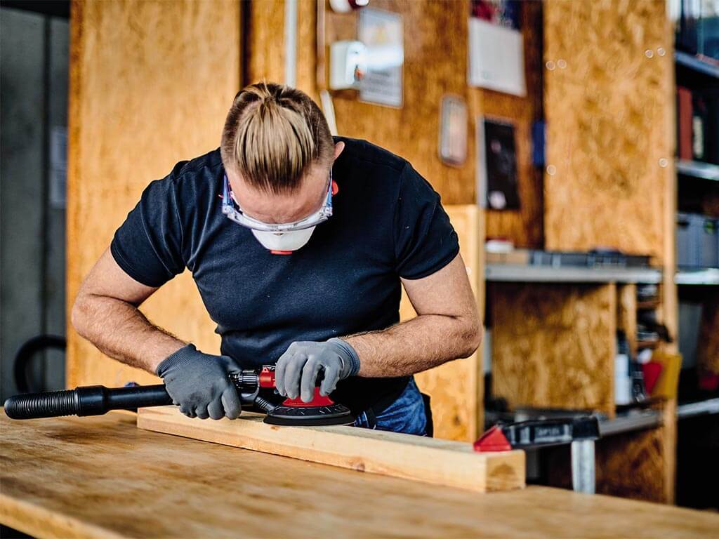 a man grinds wood