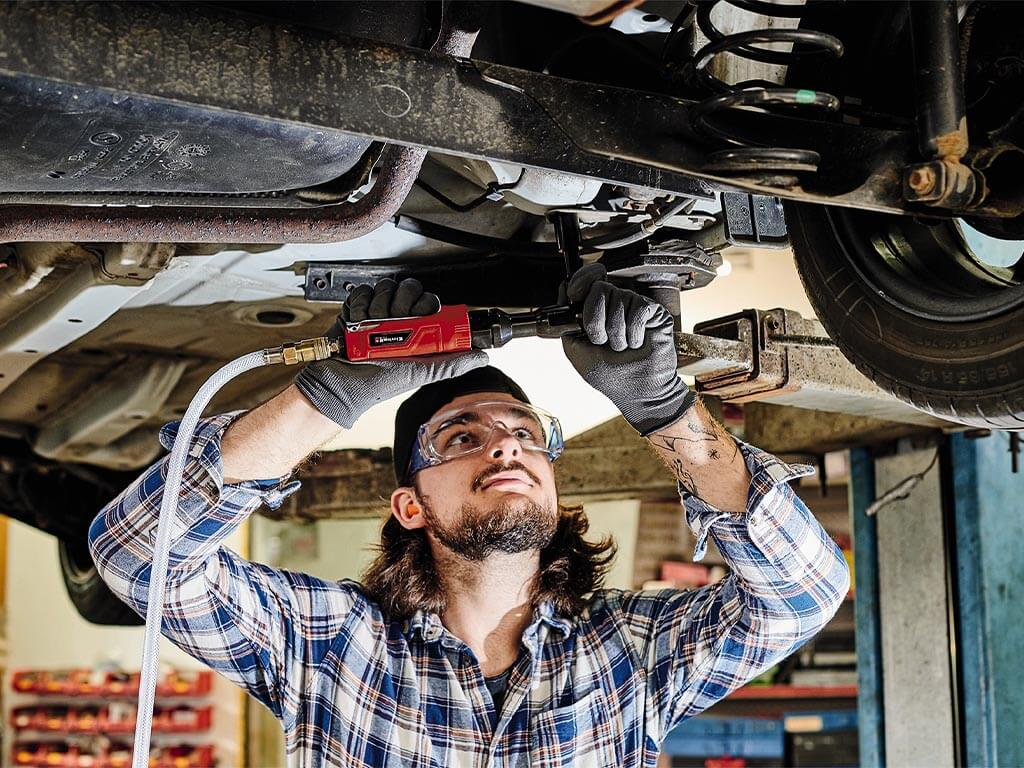 a man repairs his car