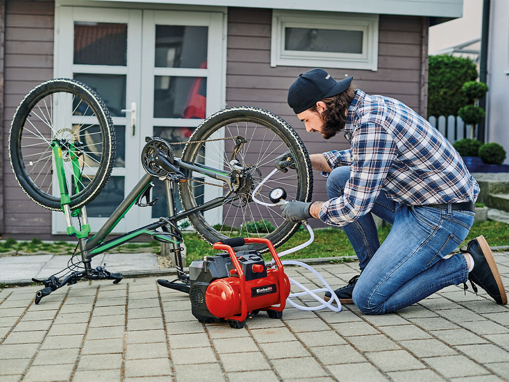   a man inflates a bicycle tire