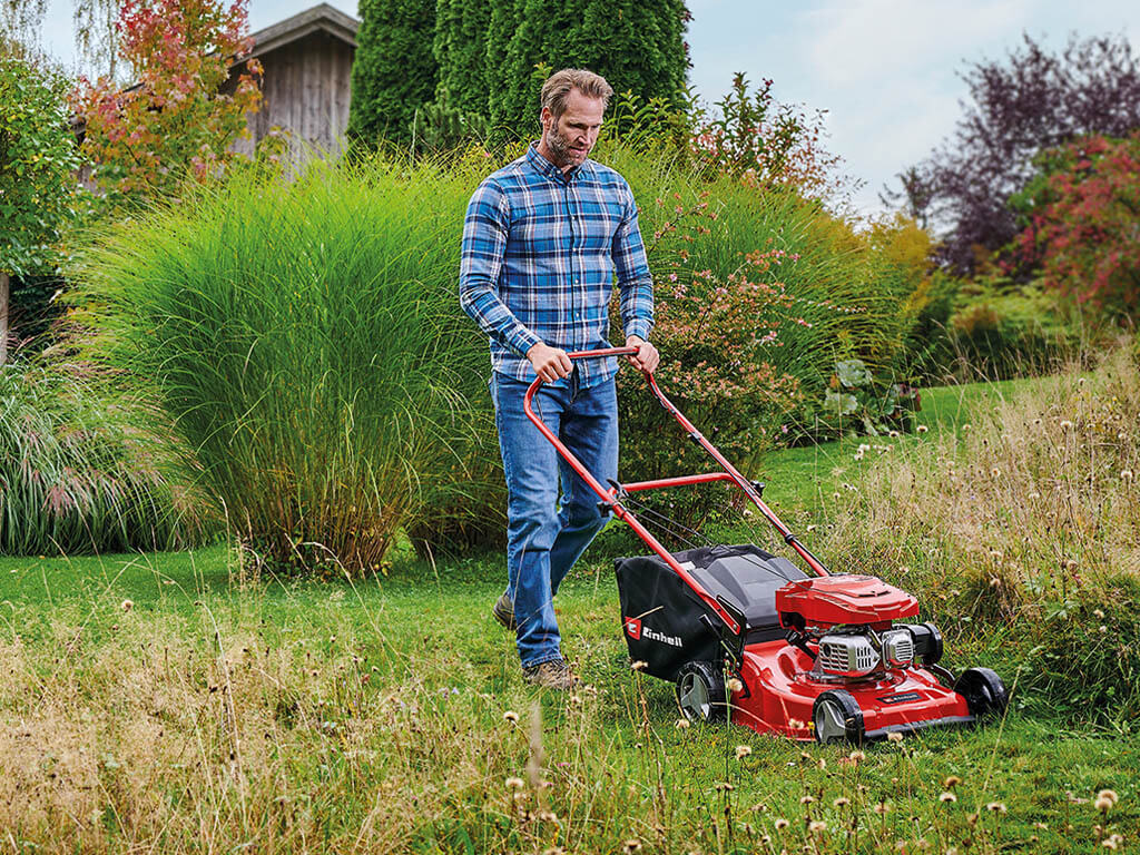 a man mows his lawn