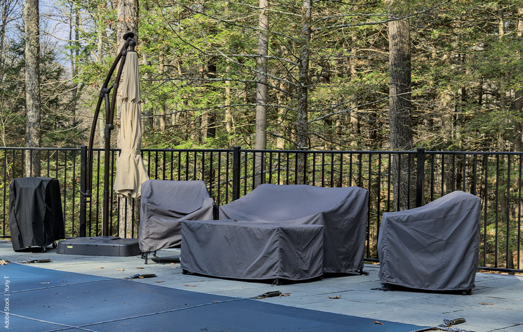 Garden furniture that is covered to be protected from winter conditions.