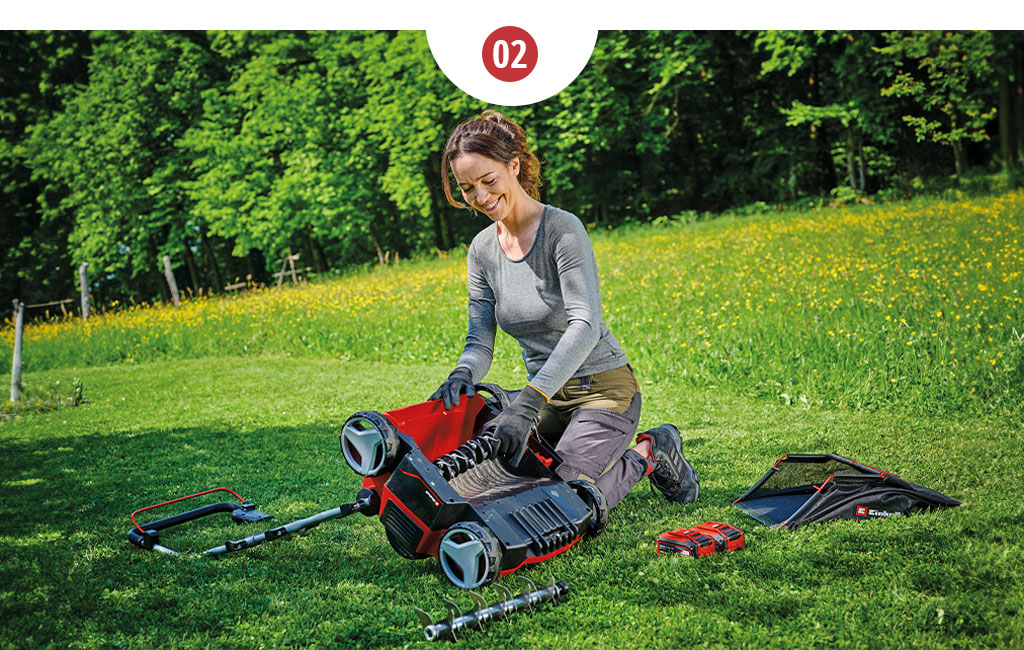 A woman kneeling in front of a scarifier fan and replacing a blade roller with a fan roller.