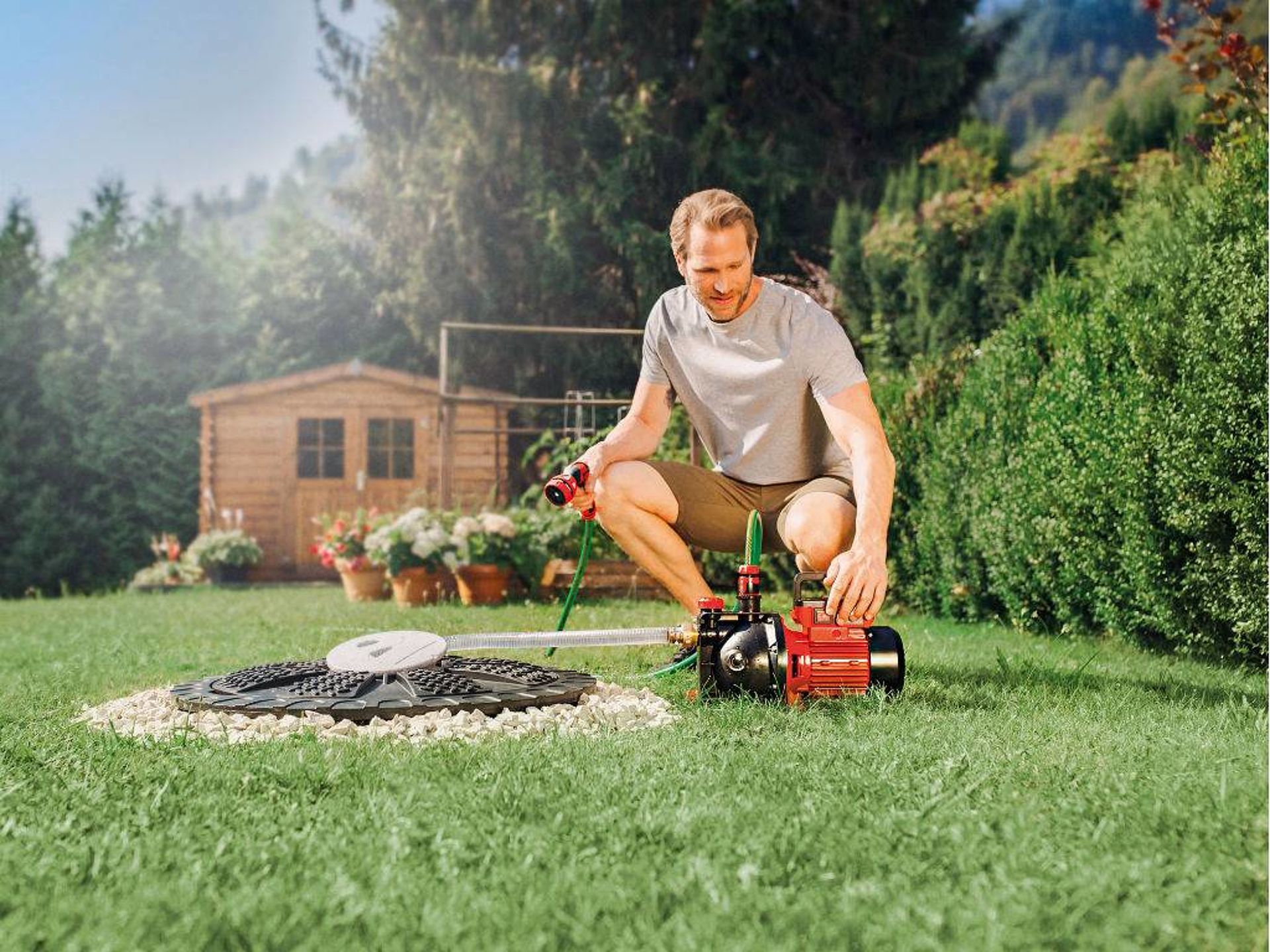 a man with a water hose and a water pump