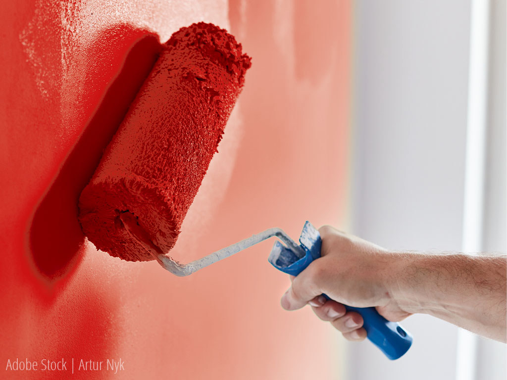 Wall is painted red with a paint roller