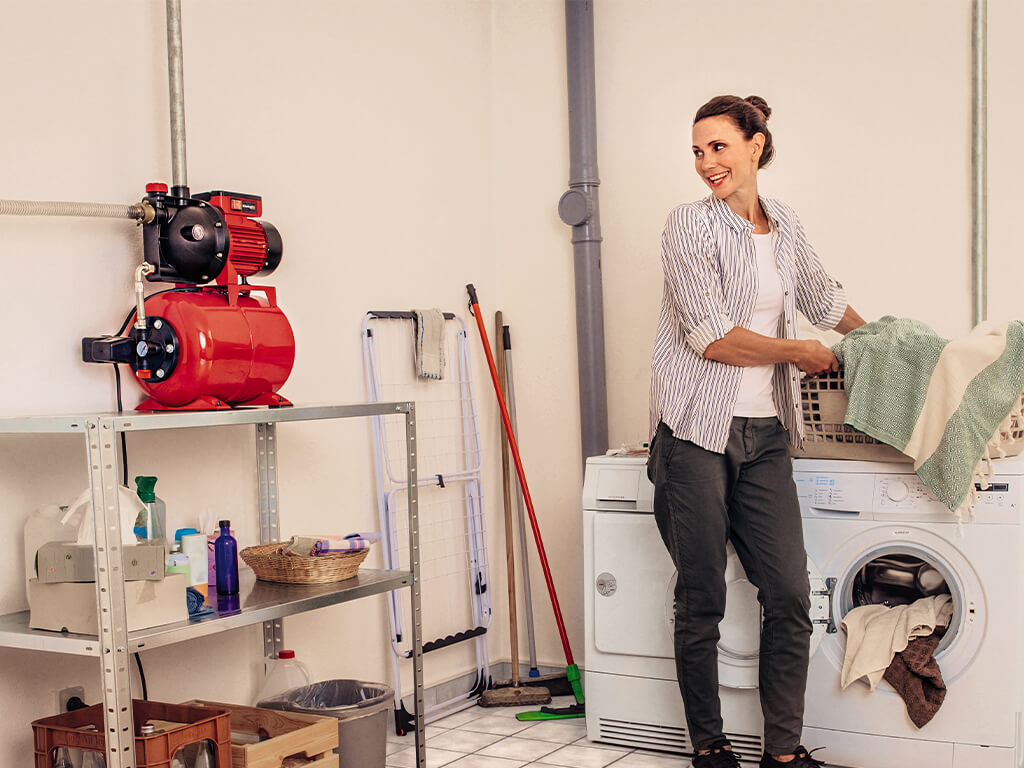 a woman washes clothes in the household room