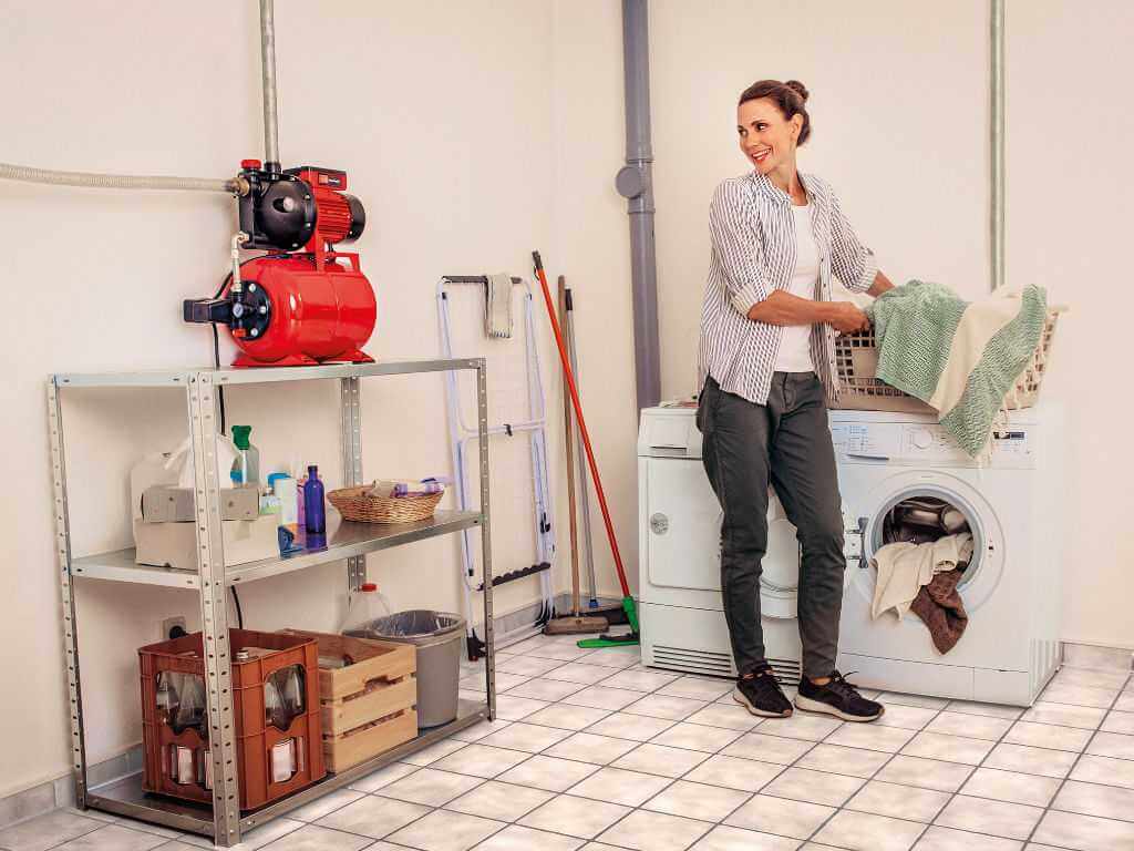 a woman washes her laundry in the household room