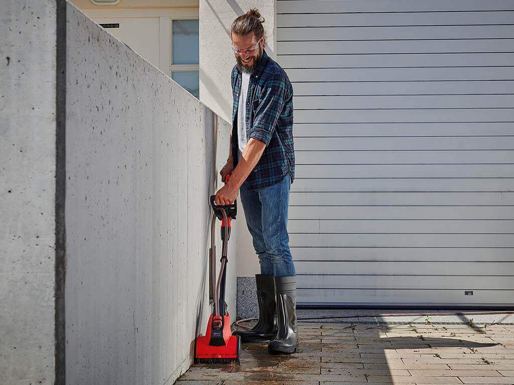 a man cleans his pavement