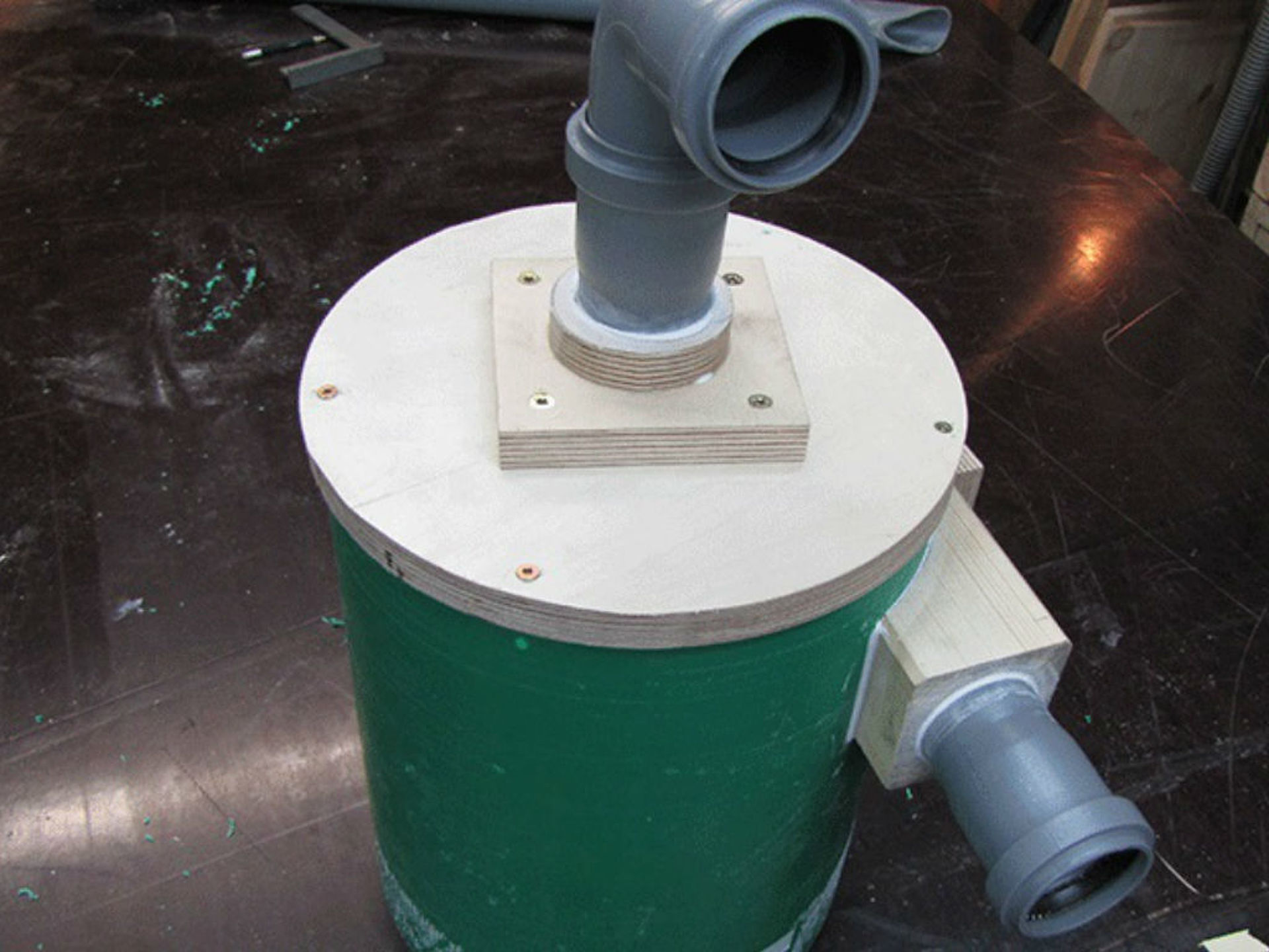 green garbage can with two pipes