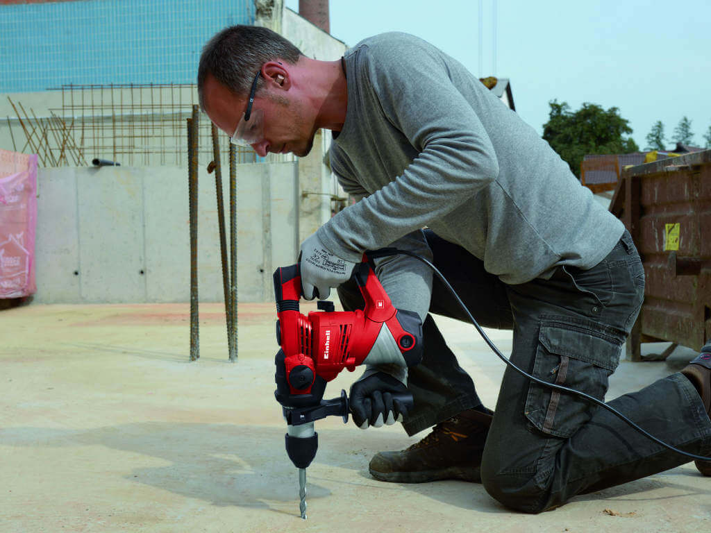 man drills hole in the ground