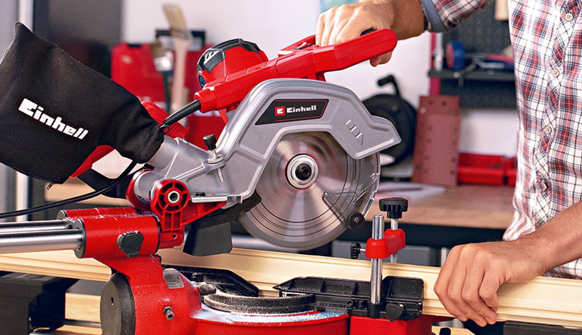 someone using the Einhell mitre saw in his workshop