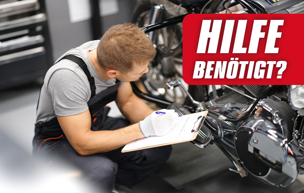 Person inspecting a motorcycle in a workshop with a checklist in hand, text in image: “Help needed?”