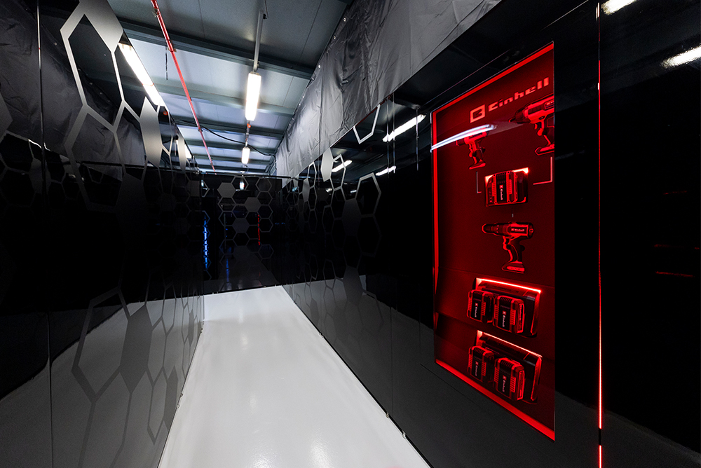 Moderner Ausstellungsbereich mit Einhell Logo in einem Gebäude.  