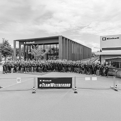 Black and white image: The Guinness World Records logo over an event photo showing Einhell tools.