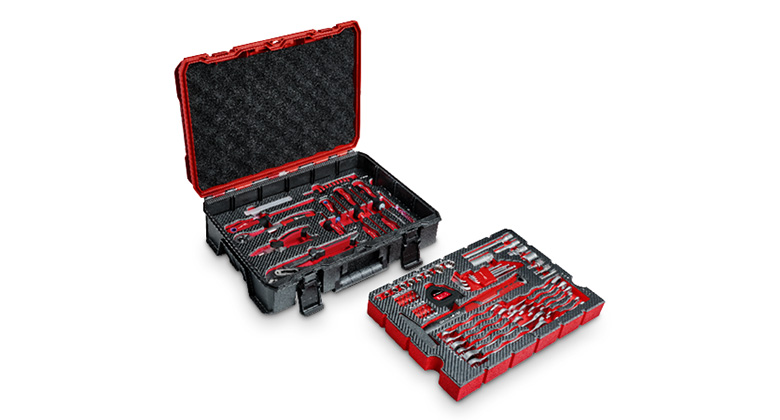 An open Einhell tool case displays neatly sorted tools in red and black foam inserts.