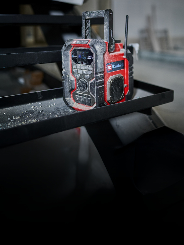 Ein verstaubtes Einhell DAB+ Radio auf einer Baustelle.